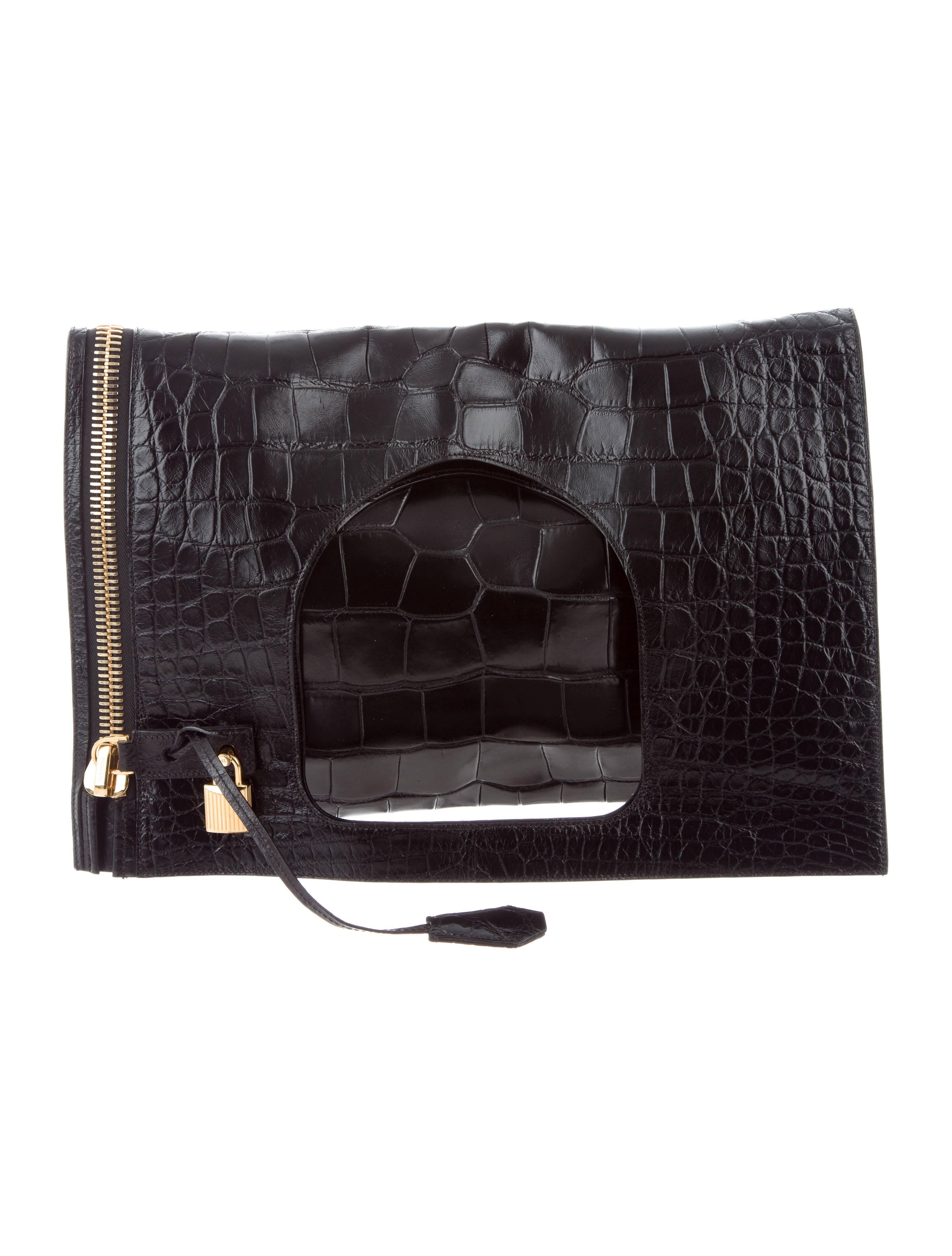 

CURATOR'S NOTES

Tom Ford Black Alligator Lock Fold Evening Tote Clutch Flap Bag with Accessories  

Original purchase price $25,895
Alligator
Gold tone hardware
Suede lining 
Side zipper closure
Made in Italy
Measures 16