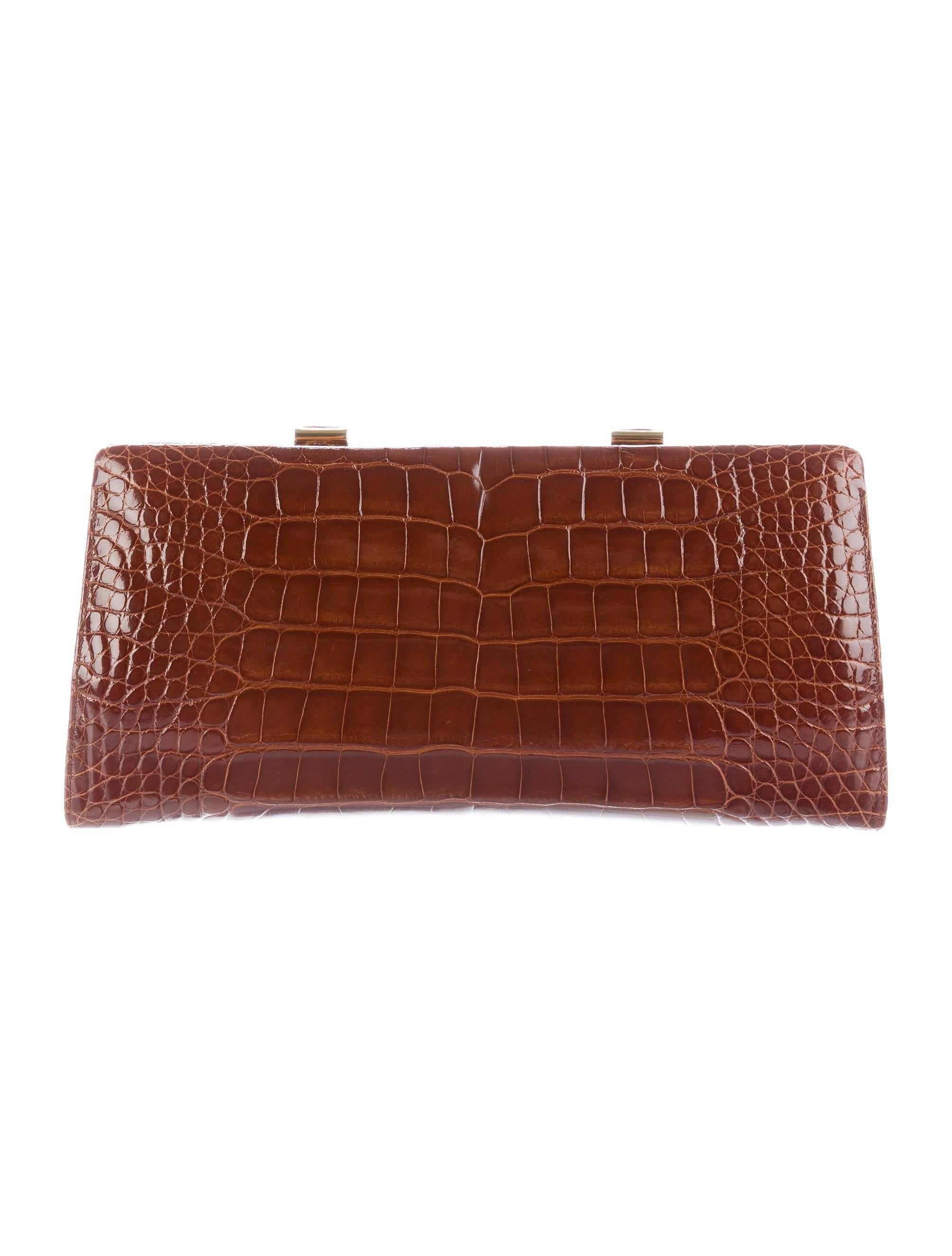 CURATOR'S NOTES

Judith Leiber New Cognac Alligator Pearl Crystal  Evening Shoulder Clutch Bag

Alligator
Gold tone hardware
Faux pearl
Crystal
Leather lining
Push lock closure
Features drop in shoulder strap and interior coin purse
Shoulder strap