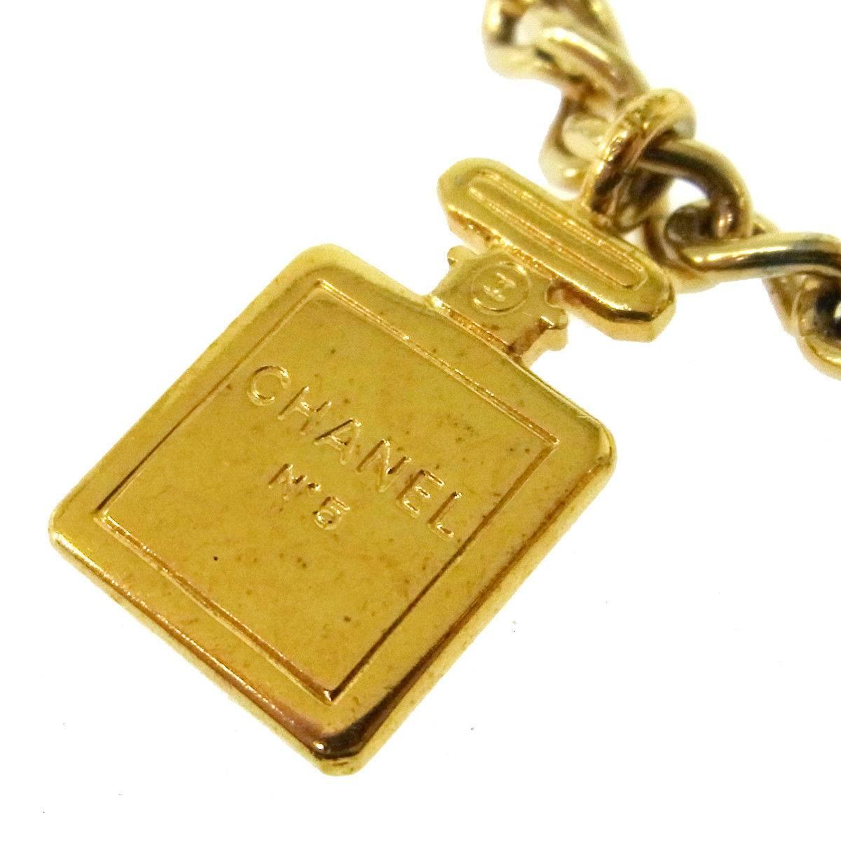Chanel Vintage No 5 Perfume Bottle Charm Chain Evening Bangle Bracelet 

Metal
Gold tone hardware
Made in Italy 
Lobster claw closure
Charms measure 0.5" W x 0.75" H
Total length 6.75"
