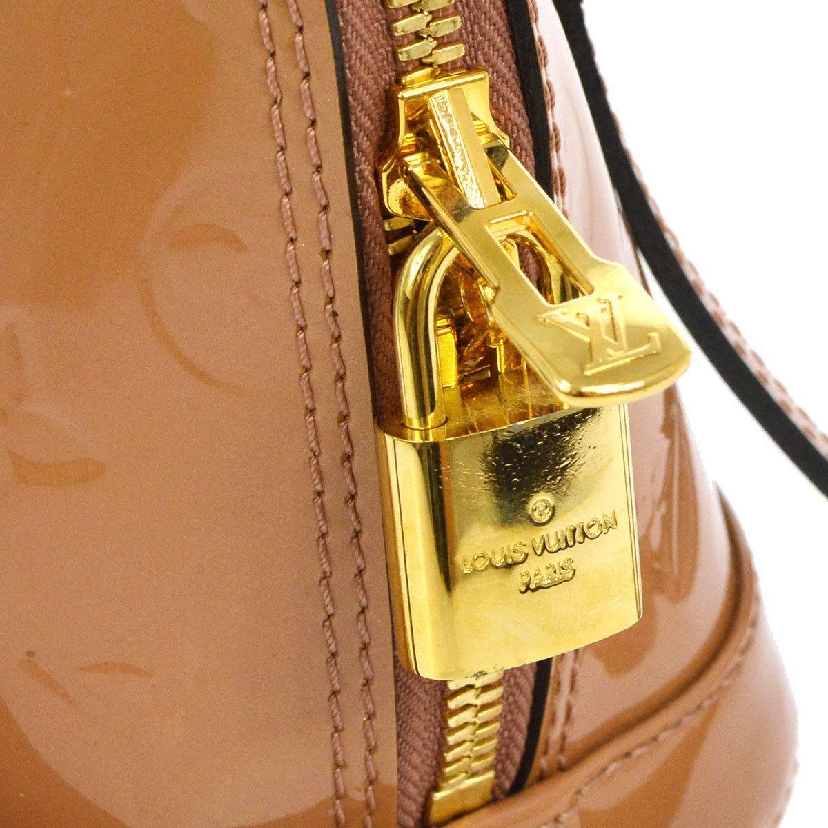 Louis Vuitton Cognac Patent Evening Top Handle Satchel Shoulder Bag With All Accessories

Patent leather
Gold tone hardware
Woven lining
Date code present
Made in France
Handle drop 4"
Measures 9.25" W x 7" H x 4.25" D 
Removable