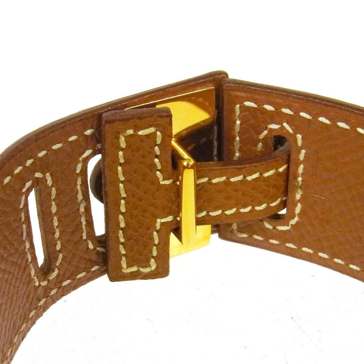 Hermes Cognac Leather Gold Buckle Charm Men's Women's Evening Cuff Bracelet 

Leather
Gold tone hardware
Adjustable buckle closure
Date code present 
Made in France
Width 1