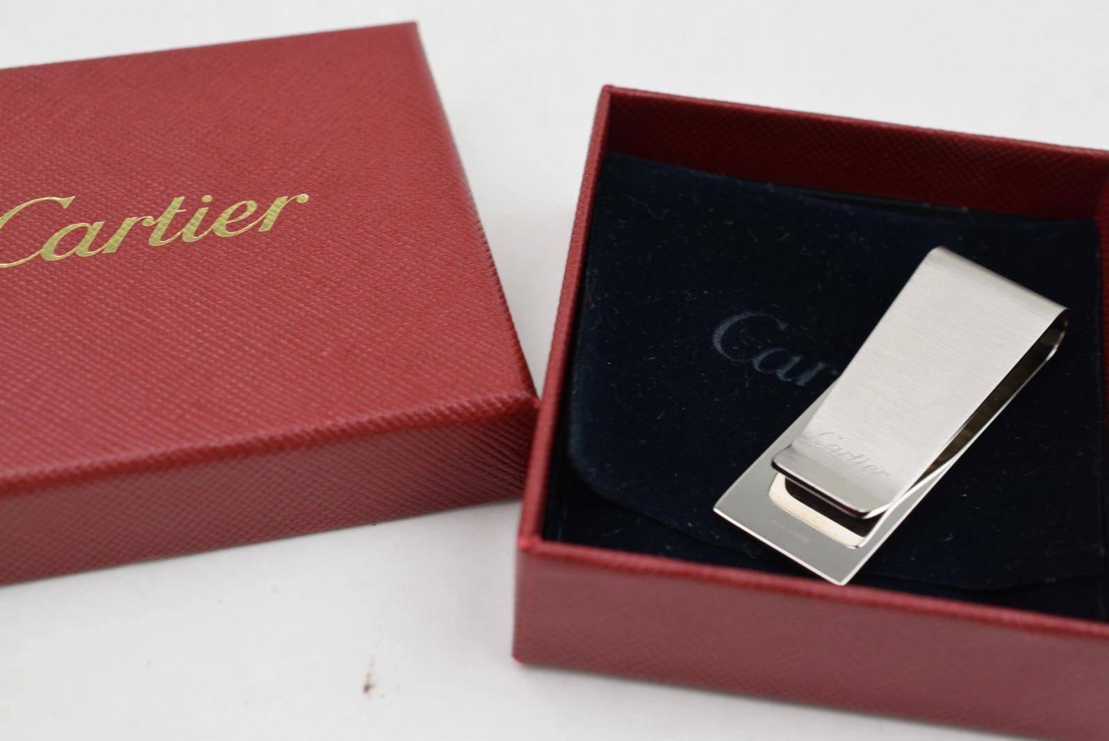 A great gift!  Cartier Metal Silver Logo Charm Men's Money Clip in Box 

Metal
Silver tone
Made in Spain
Measures 0.70