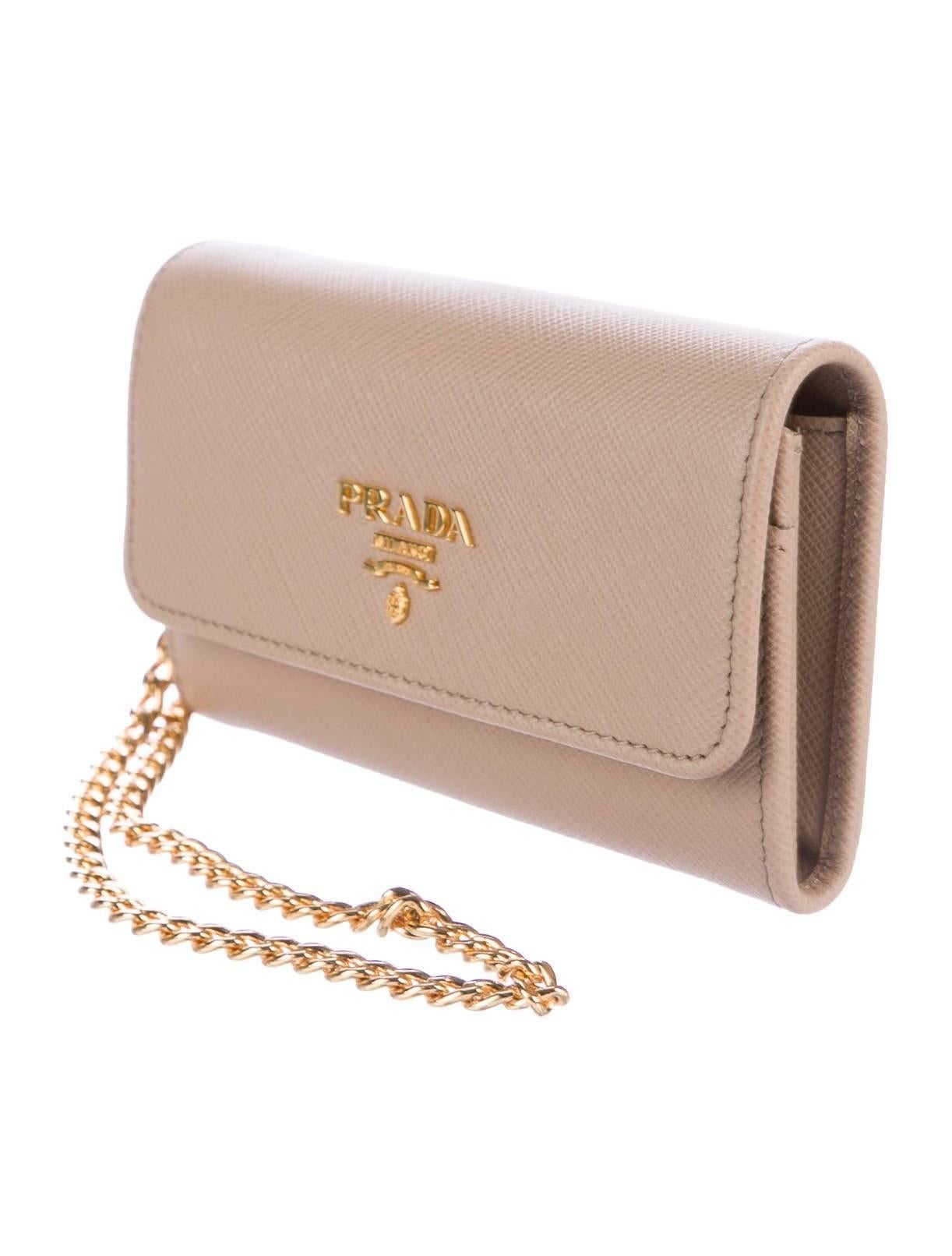 CURATOR'S NOTES

Prada New Nude Leather Gold 2 in 1 Wallet on Chain WOC Clutch Flap Bag in Box

Leather
Gold tone hardware
Snap closure
Leather lining
Features three card slots 
Measures 5.25