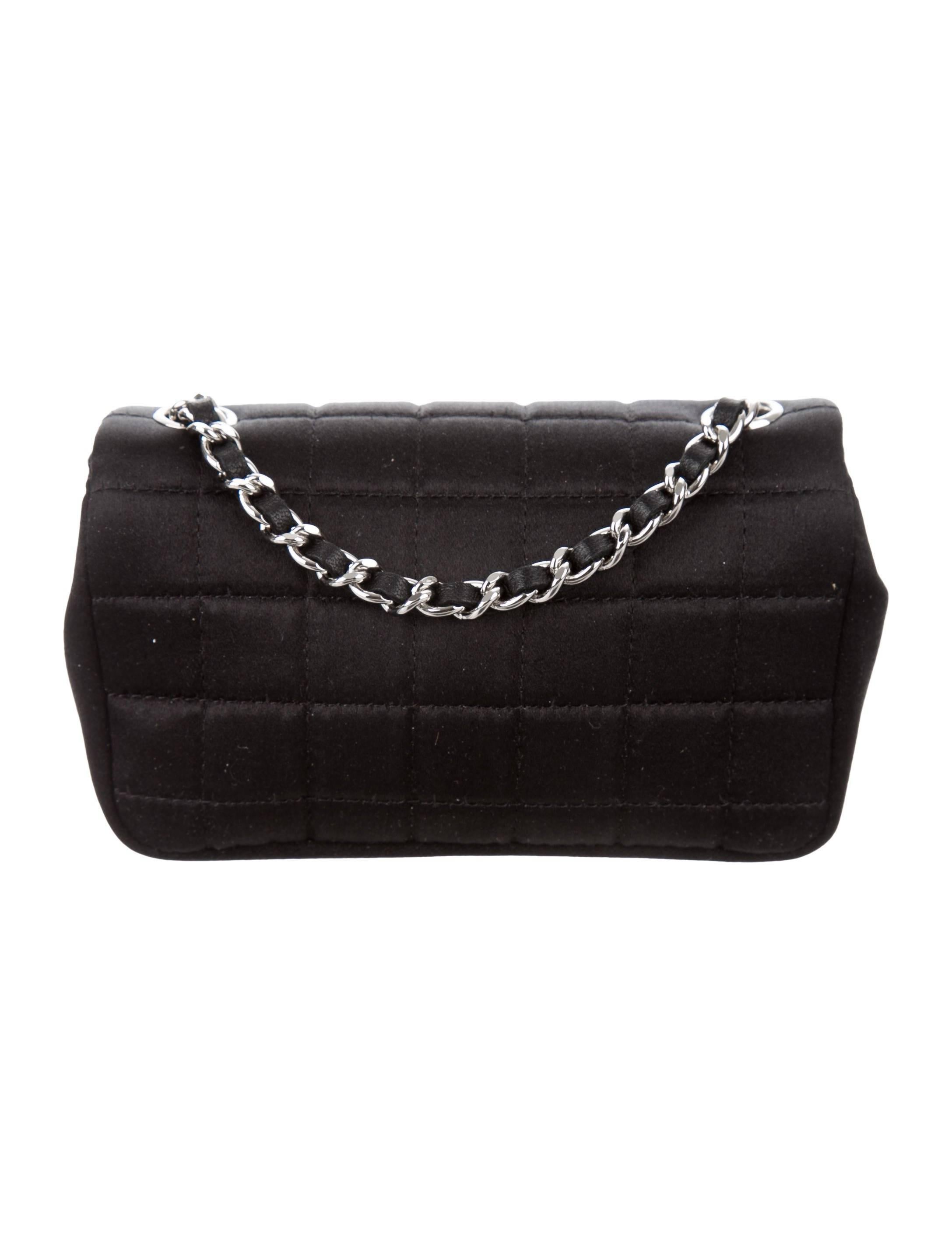 Chanel New Black Satin Silver Racket Lipstick Small Evening Shoulder Flap Bag

Satin 
Silver-tone hardware
Woven lining
Turn-lock closure 
Date code present
Shoulder strap drop 23"
Includes original Chanel authenticity card
Measures 5" W x
