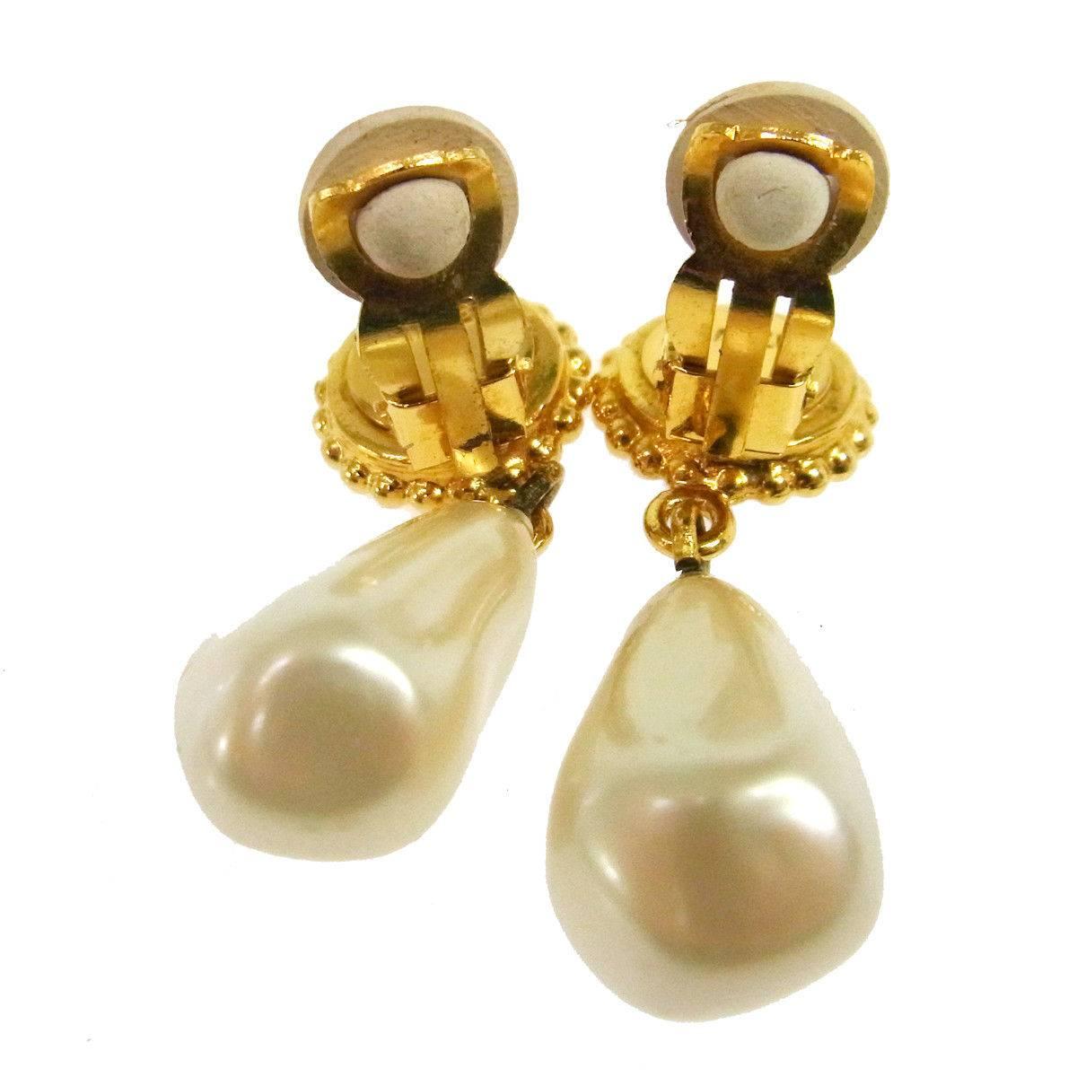 Chanel Gold Pearl Clover Charm Dangle Drop Evening Earrings in Box

Metal
Faux pearl
Gold tone hardware
Clip on closure
Width 0.50