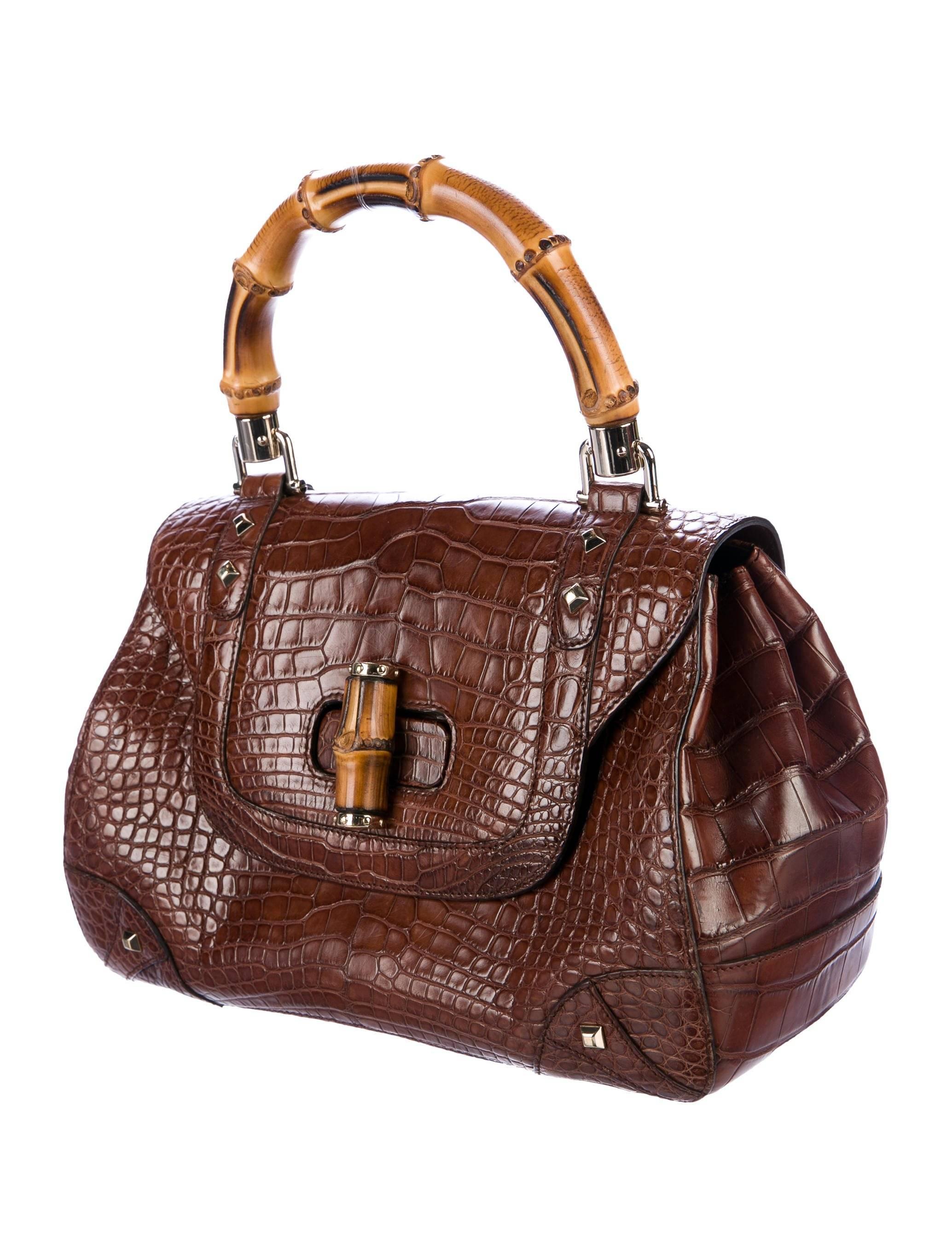 Gucci Cognac Brown Alligator Exotic Skin Leather Bamboo Evening Satchel Bag

Alligator 
Bamboo
Silver tone hardware
Leather lining
Turn lock closure
Handle drop 5"
Measures 11.5" W x 8" H x 4.5" D 
Includes original Gucci dust bag