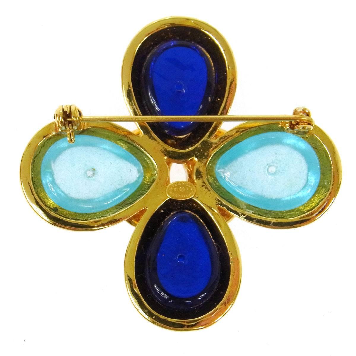 Chanel Gold Charm Cross Gripoix Turquoise Evening Pin Brooch 

Gripoix
Metal
Gold tone 
Pin closure
Made in France 
Measures 2" W x 2" H