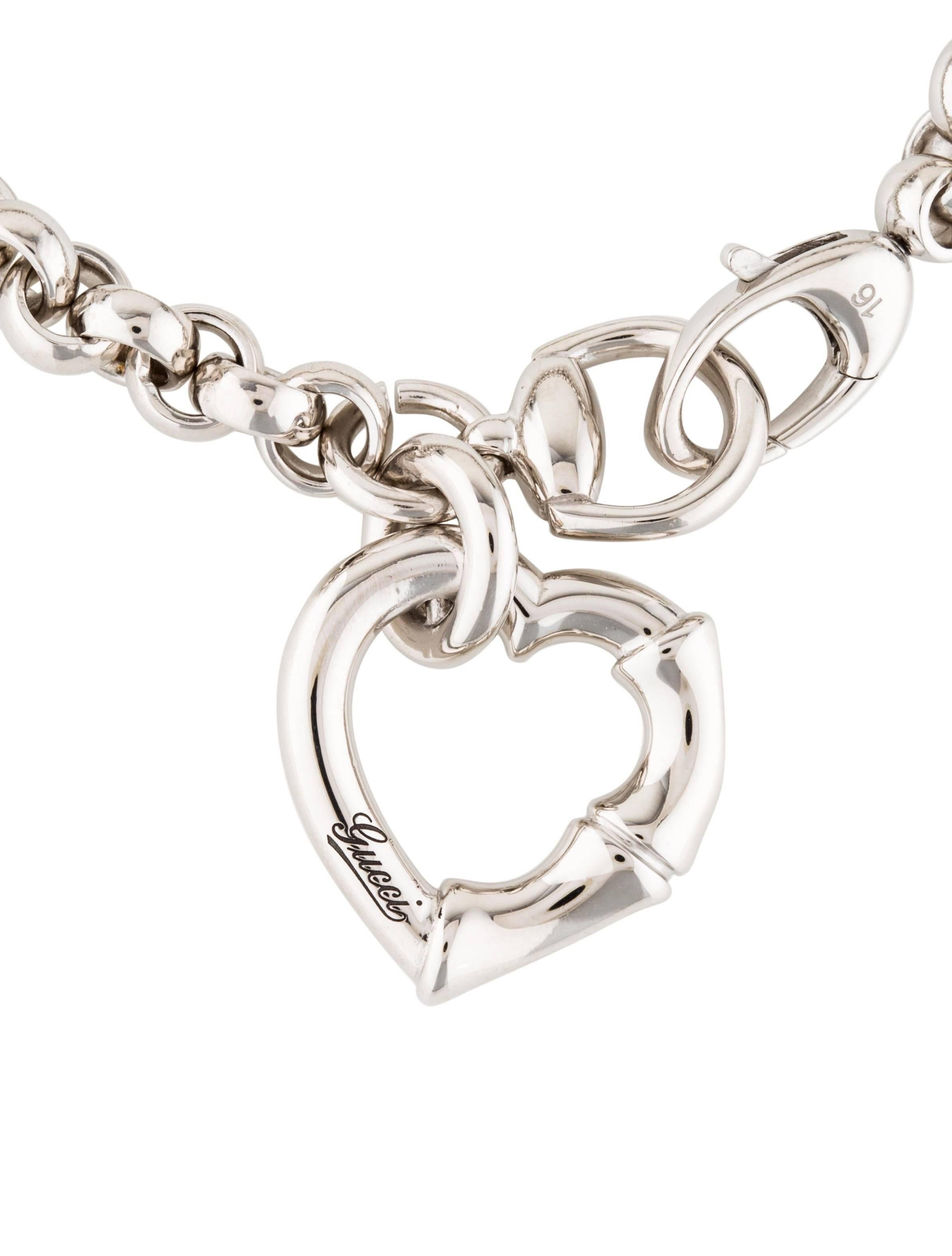 Gucci New Sterling Silver Chain Charm Bamboo Heart Bangle Bracelet in Box

Sterling silver - 925
Lobster clasp closure
Signed
Made in Italy 
Charm diameter 0.75