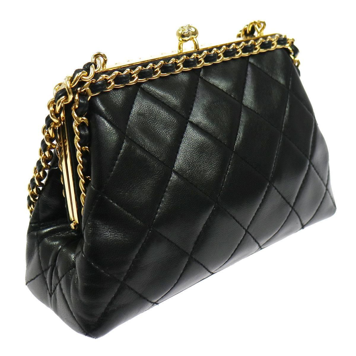 Chanel Black Lambskin Wraparound KissLock Party Evening Top Handle Shoulder Bag in Box

Lambskin leather
Gold tone hardware
Kisslock closure
Leather lining
Date code present
Made in Italy
Shoulder strap drop 8