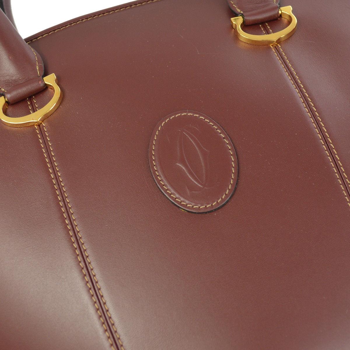 Cartier Burgundy Wine Leather Charm Small Shoulder Bucket Top Handle Satchel Tote Bag in Box

Leather
Gold tone hardware
Woven lining
Zipper closure
Made in Italy
Handle drop 6