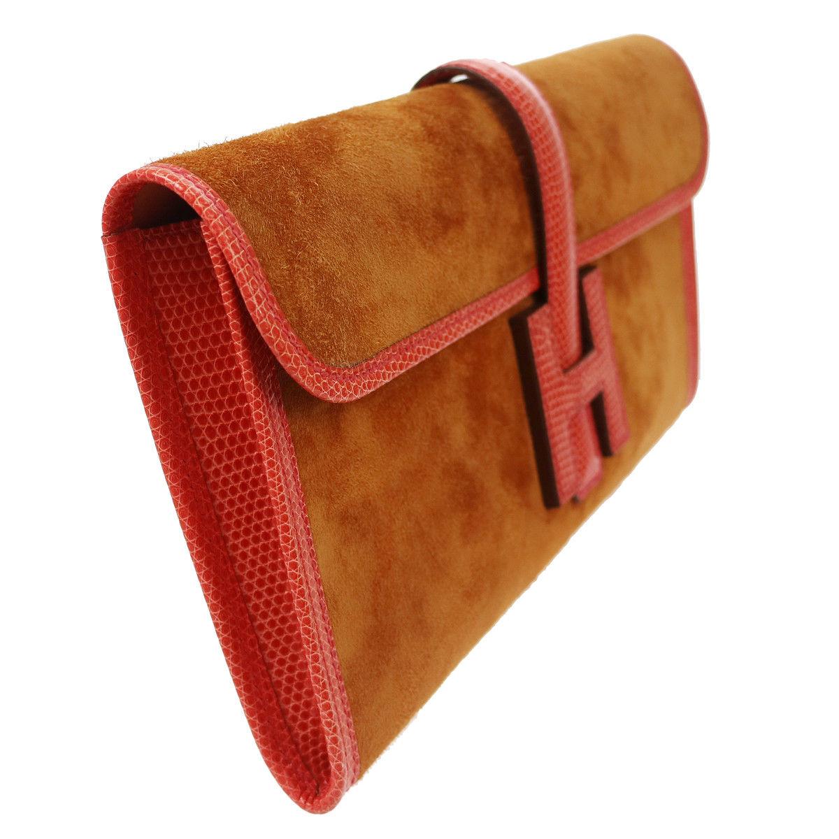 Hermes Rare Cognac Brown Suede Lizard Coral Trim 'H' Logo Evening Clutch Bag In Box

Suede
Lizard
Leather lining
Slip in buckle closure
Date code present
Made in France 
Measures 11.5