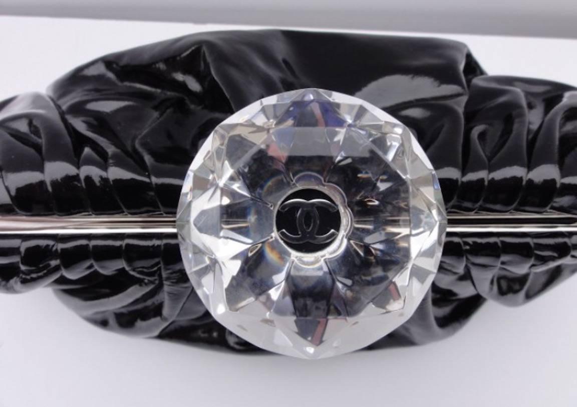 CURATOR'S NOTES

The ultimate evening bag for all your special occasions and nights out on the town!  Stunning black vinyl Chanel clutch featuring beautiful diamond jewel kiss lock CC closure.  We promise you will grab for it again and