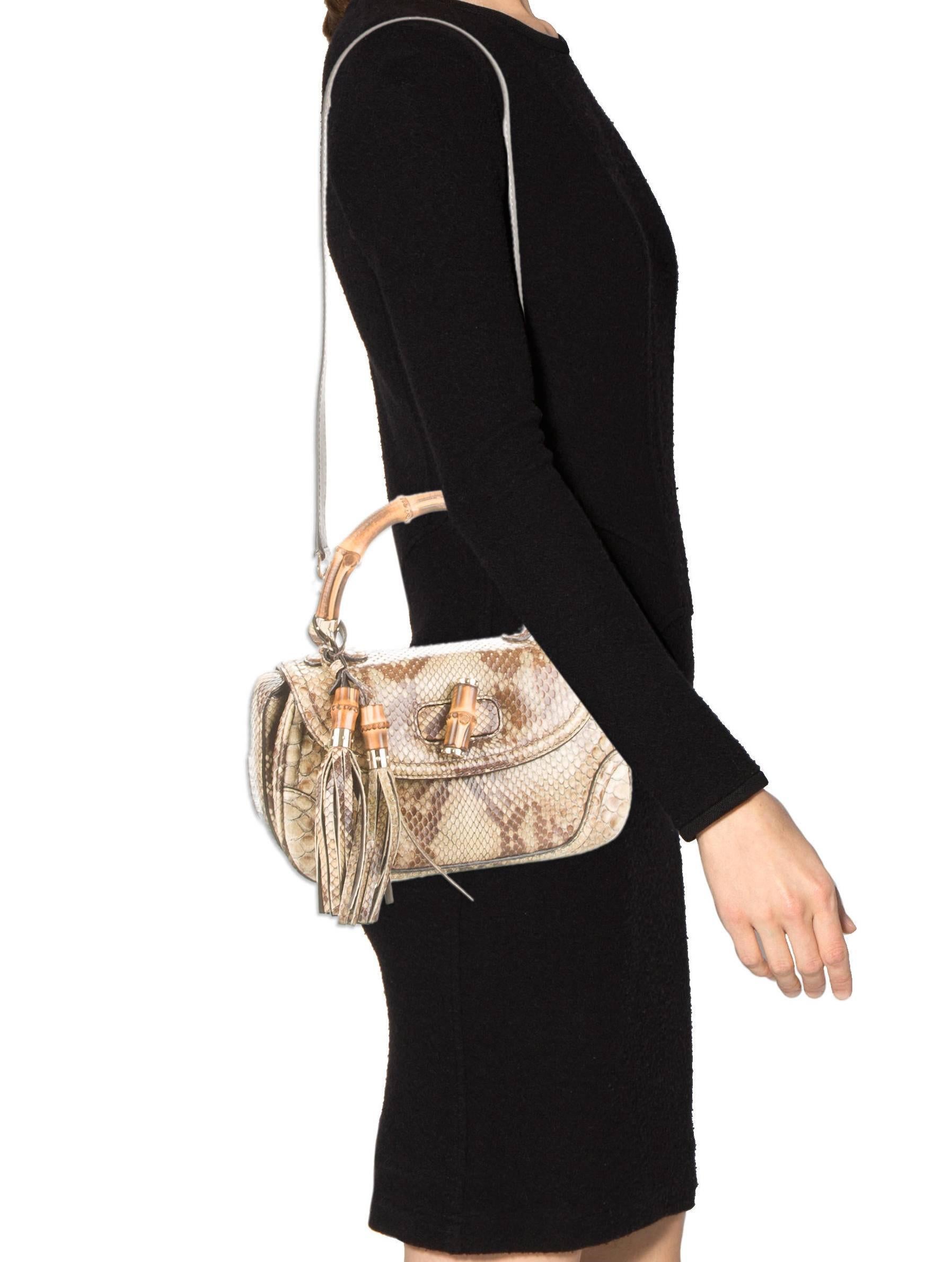 CURATOR'S NOTES

All of your favorites handcrafted into one! Stunning python snakeskin Gucci satchel shoulder bag featuring bamboo top handle and removable shoulder strap.

Style Tip: Dangle it from your wrist or wear it cross body style for