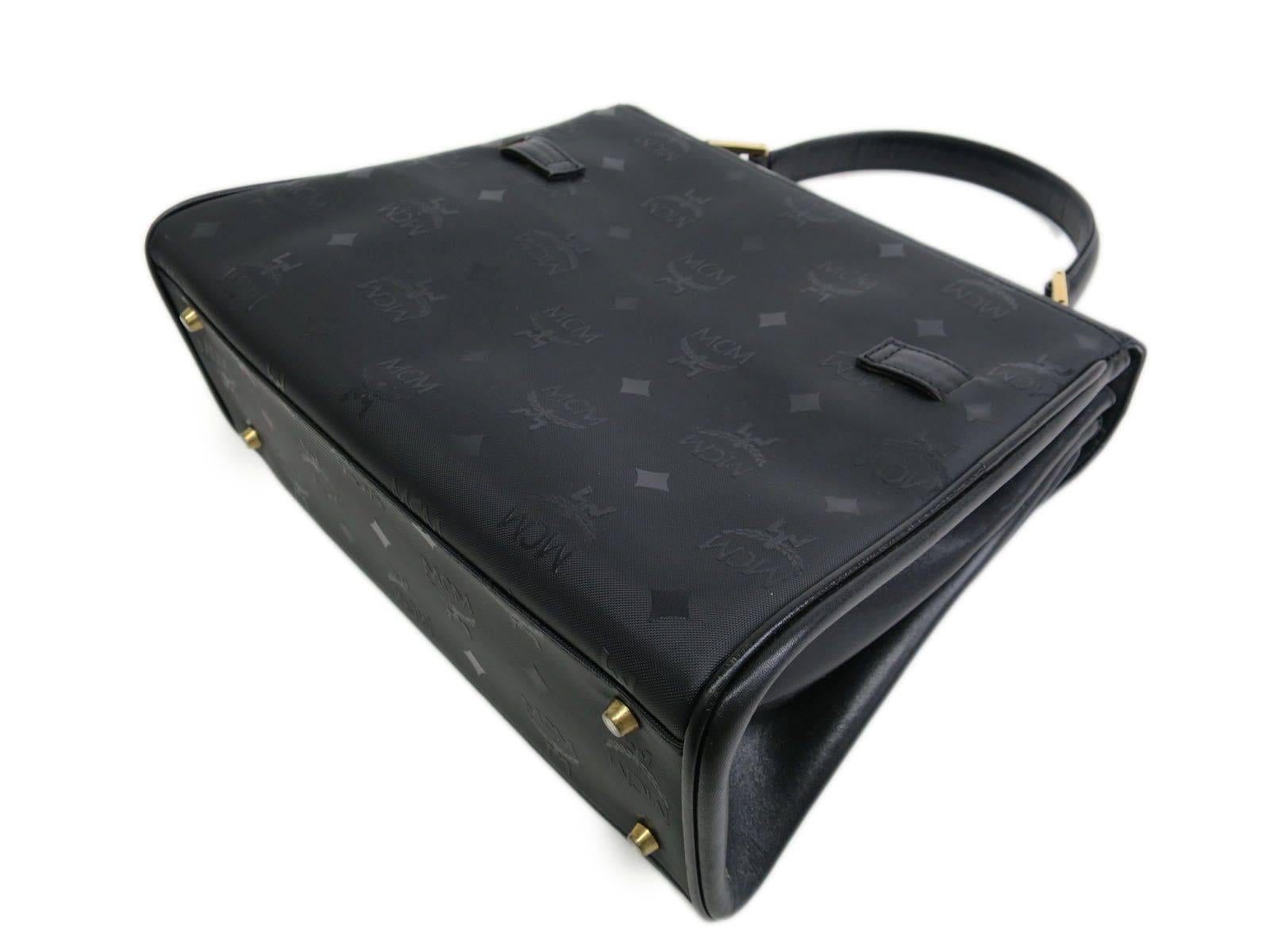 CURATOR'S NOTES

This isn't your mother's Kelly bag.  Timeless and classic MCM black vinyl logo Kelly-style box satchel bag featuring gold hardware and turn lock closure. Substantial in size.  A well preserved and beautiful gem.

Vinyl
Gold