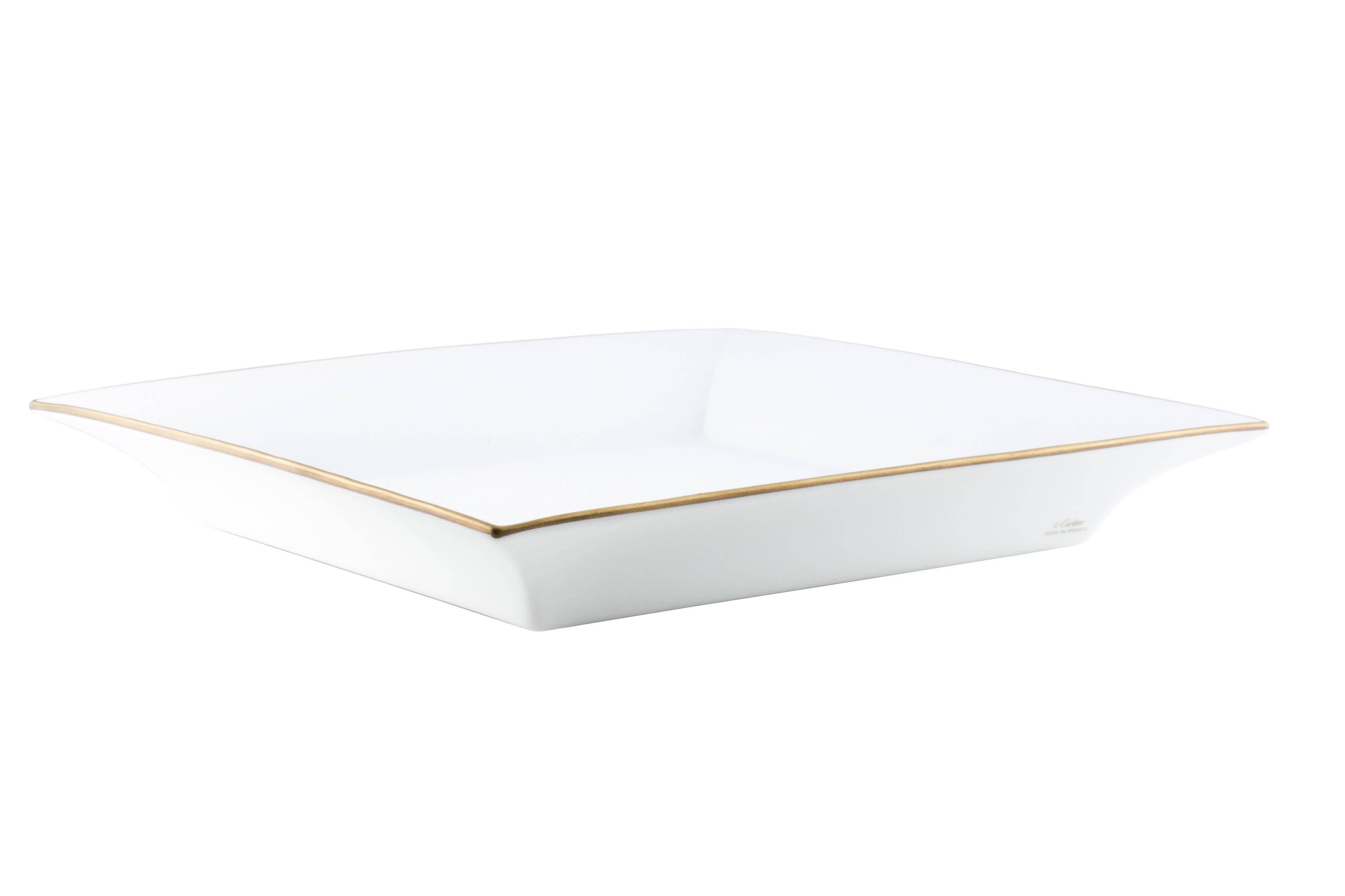 A stunning piece to accent any coffee table, buffet, office desk or vanity, this porcelain NEW Cartier tray features a Jaguar motif at the inset and rich gold trim. Original Cartier box included.

Porcelain
Gold trim
Signed underside
Made in
