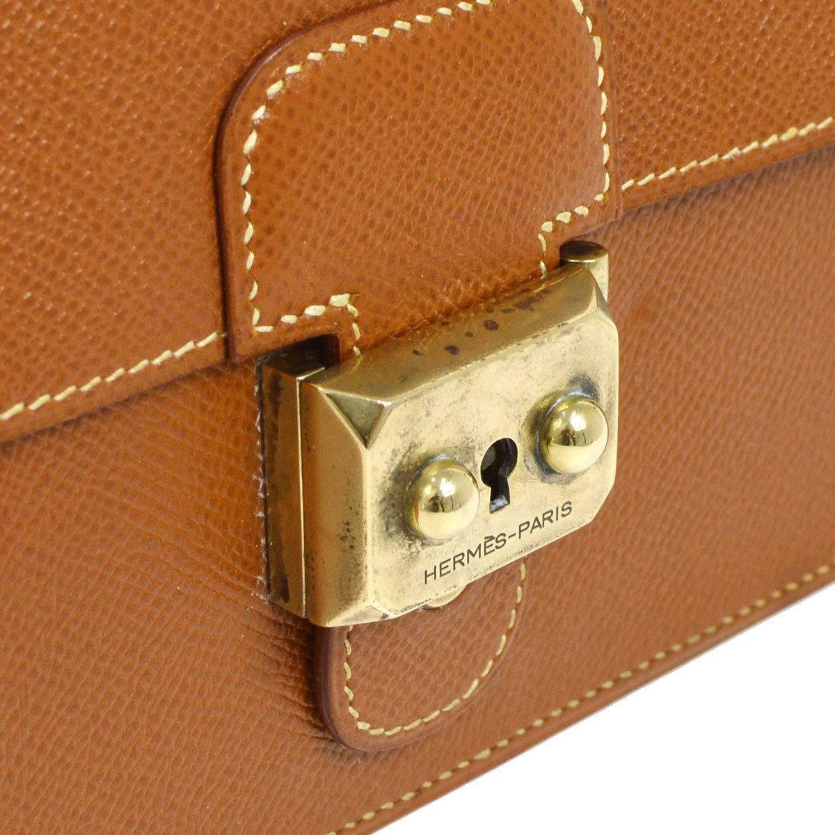 CURATOR'S NOTES

Hermes Vintage Cognac Leather Evening Flap Clutch in Box and Accessories  

Leather (Togo)
Gold tone hardware
Date code Circle W
Made in France
Measures 8" W x 6.75" H x 1.5" D 
Include original Hermes keys,