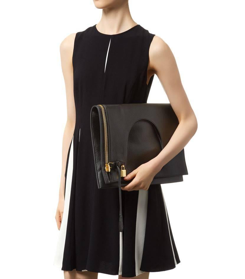 CURATOR'S NOTES

Tom Ford Black Leather Gold Lock 2 in 1 Evening Clutch Crossbody Shoulder Bag  

Leather
Silver tone hardware 
Fold over closure
Woven lining
Made in Italy
Shoulder strap drop 21
