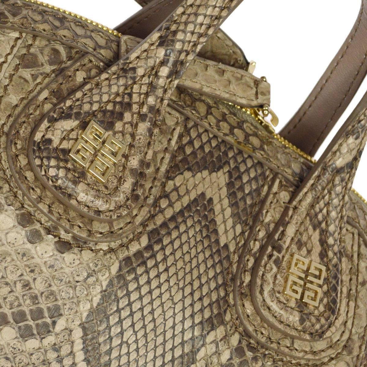 CURATOR'S NOTES

Givenchy Snakeskin Nightingale Carryall Travel Top Handle Satchel Tote Shoulder Bag  

Snakeskin
Gold tone hardware
Zipper closure
Leather lining
Made in Italy
Handle drop 4"
Removable shoulder strap drop 24"
Measures
