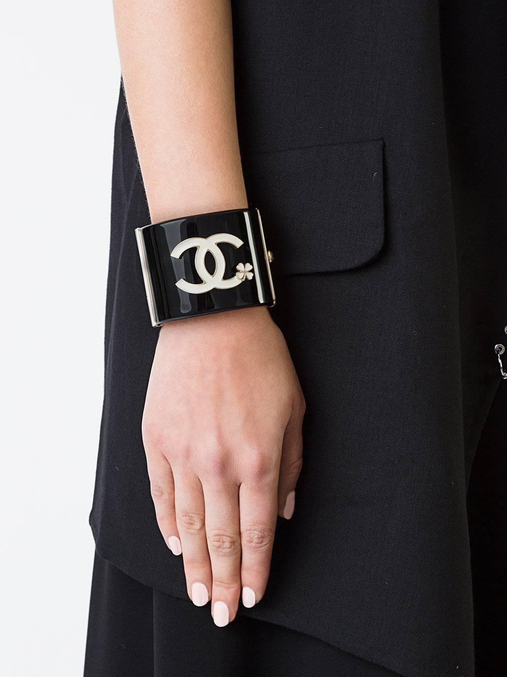 Chanel Like New Black Gold Clover Charm Evening Cuff Bracelet 
Plastic
Metal 
Gold tone hardware
Push hinge closure
Made in Italy
Width 2