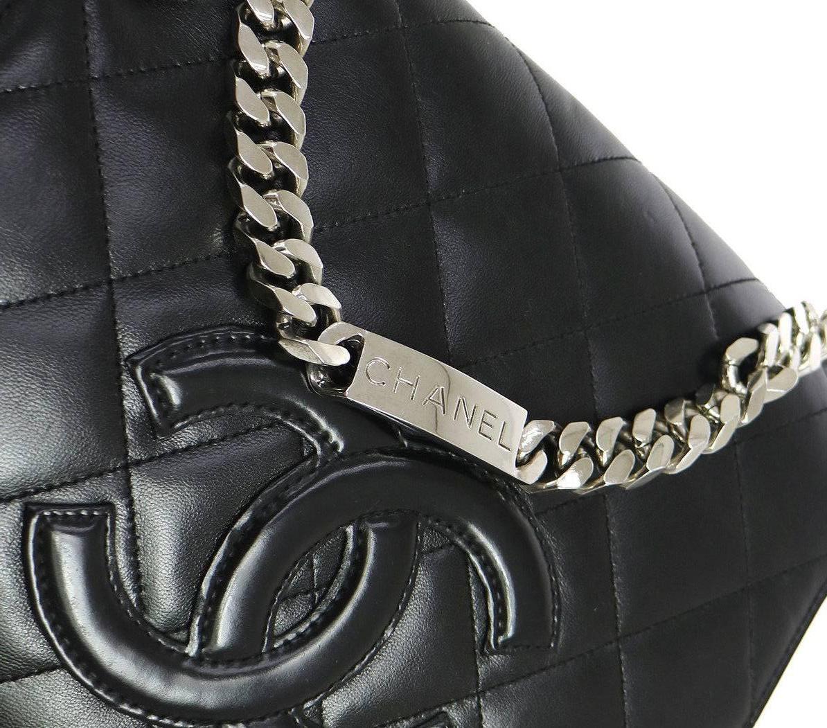 Chanel Black Lambskin Silver Chain Top Handle Satchel Evening Flap Shoulder Bag

Leather
Silver tone hardware
Leather lining
Date code present
Made in France
Handle drop 4"
Measures 8.75" W x 8.25" H x 4" D  
Includes original