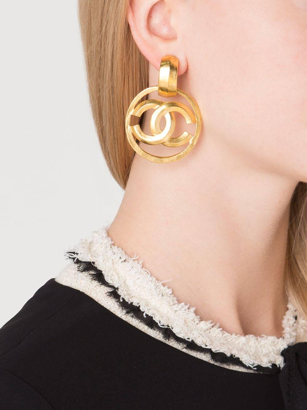 Chanel CC Gold Charm Round Circle Hoop Doorknocker Large Dangle Earrings in Box

Metal
Gold tone
Clip on closure 
Made in France
Width 1.5