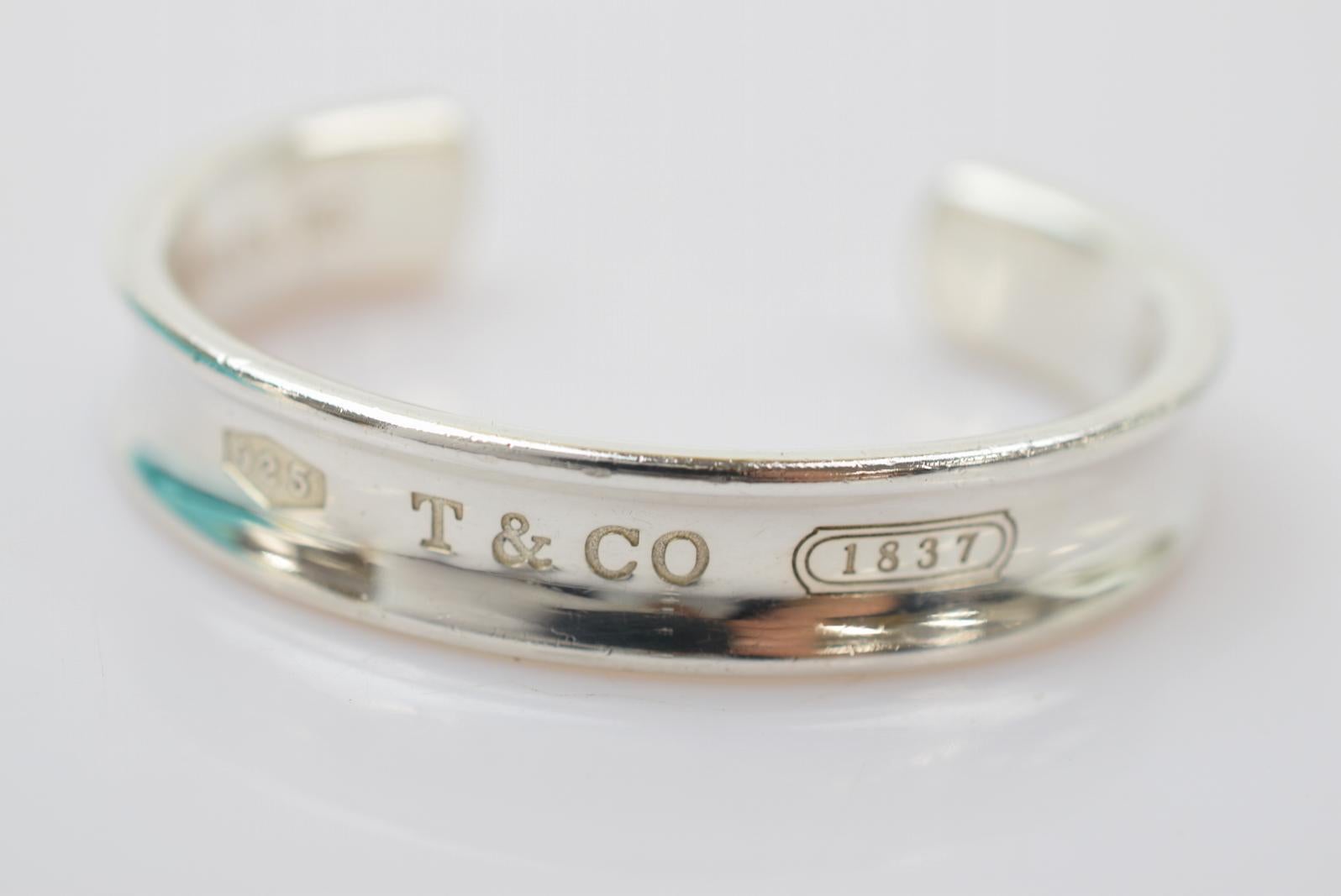 Tiffany & Co Sterling Silver Logo Cuff Bangle Bracelet in Box

Sterling silver - 925
Slip on
Made in Italy
Inner circumference ~6