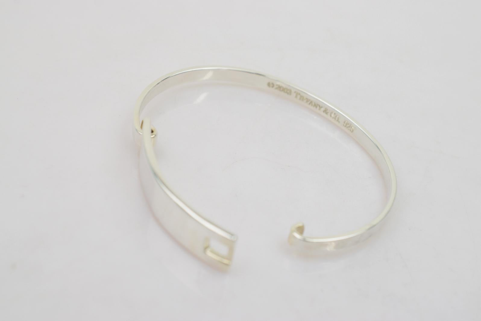 Tiffany & Co. Sterling Silver Hook Cuff Bangle Bracelet in Box

Sterling silver - 925
Hook closure
Inner circumference ~6