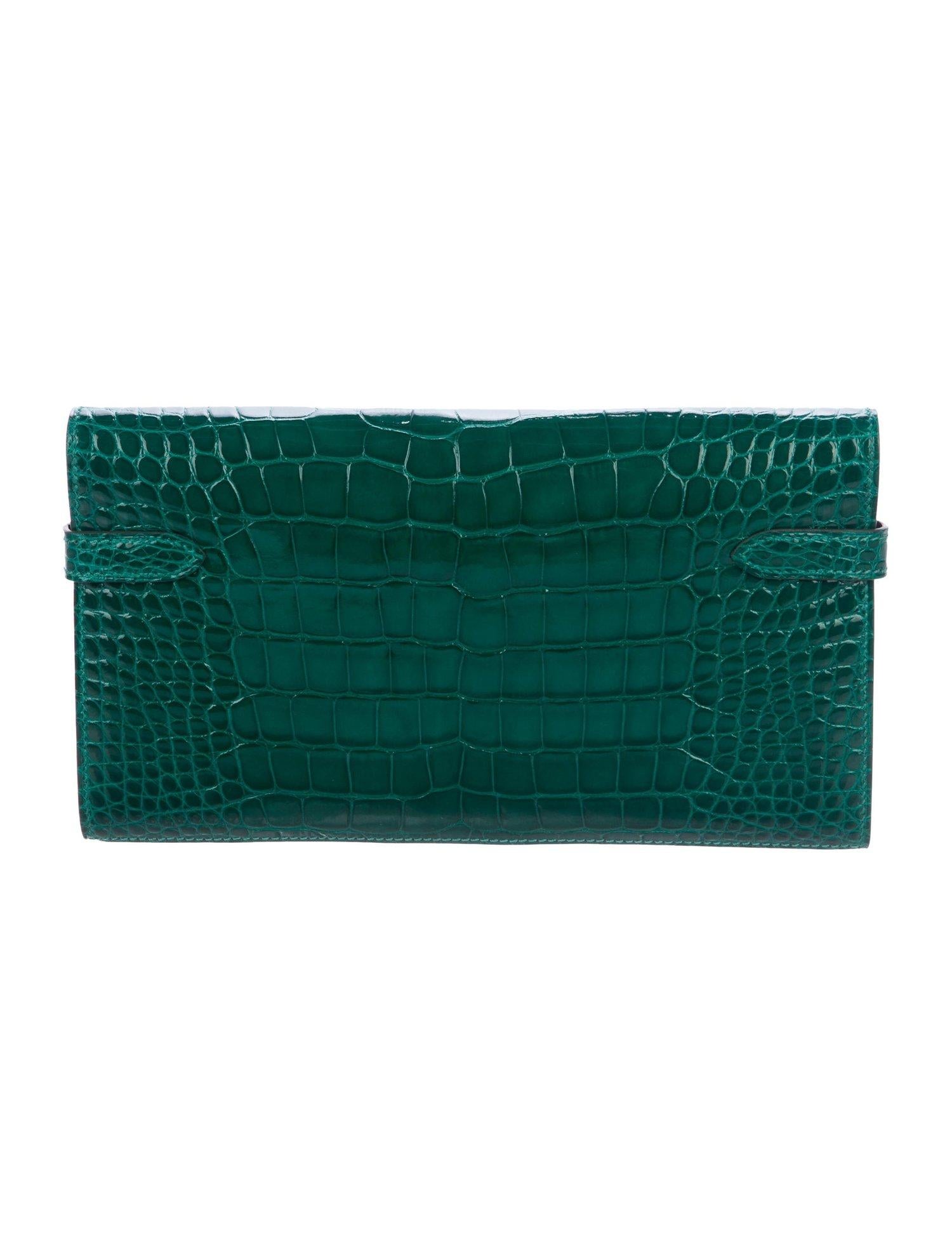 Hermes Kelly Green Alligator Gold Evening Kelly Clutch Wallet Bag in Box

Alligator 
Gold tone hardware
Turnlock closure
Leather lining
Date code present
Made in France
Features zip closure, bill compartment and 12 card slots 
Measures 7.75