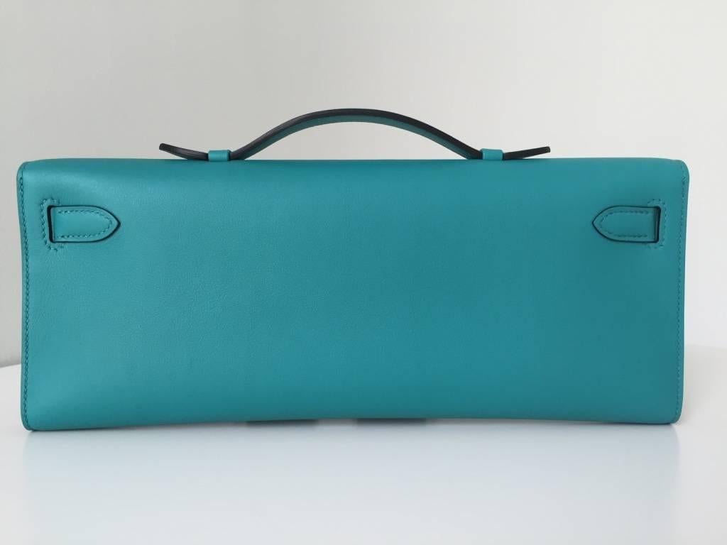 Vibrant greenish blue 'blue poan' (peacock blue). Stunning new 2016 colour, probably the best new colour of 2016!

FIRST Luxury has this Kelly Cut clutch available in swift leather with gold hardware. Comes as a full set with original packaging