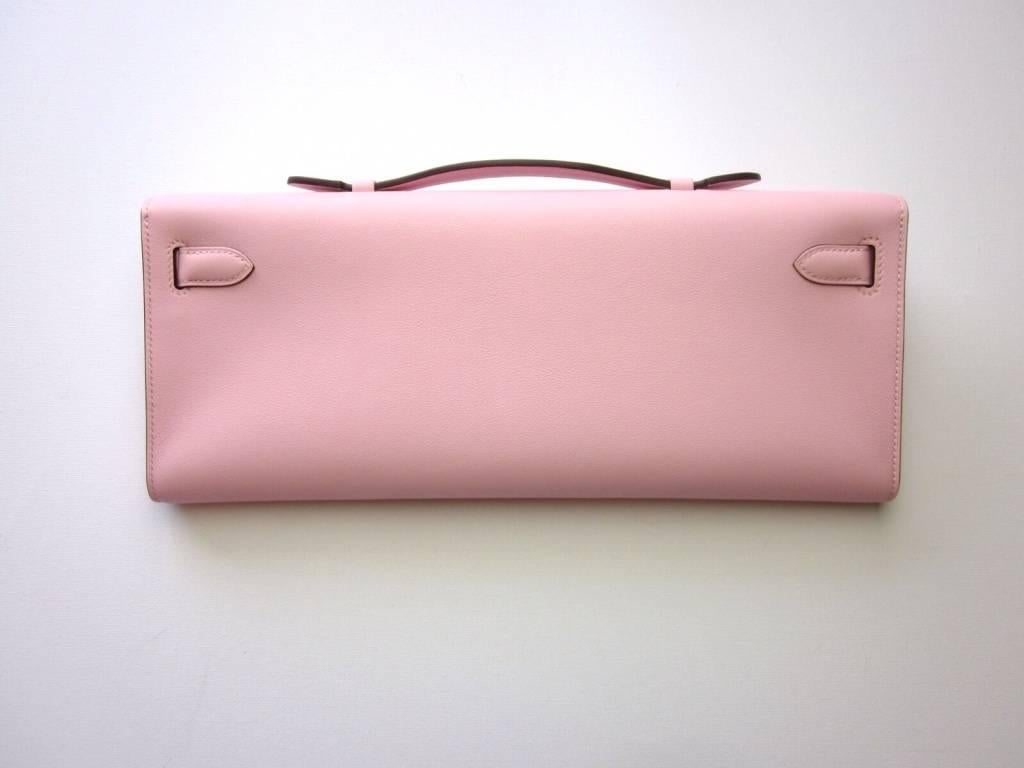 Kelly Cut pochette made in soft pink 'Rose Sakura' swift leather with palladium hardware. An amazing piece! Reasonable priced! Don't wait as it will sell super fast!