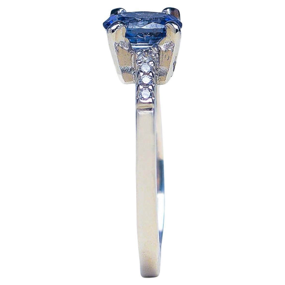 Introducing our 1ct Oval Blue Sapphire and Natural White Zircon Gemstone engagement Ring, a true masterpiece that will elevate your style and captivate hearts. This stunning ring boasts a natural oval blue sapphire at its center, exuding elegance