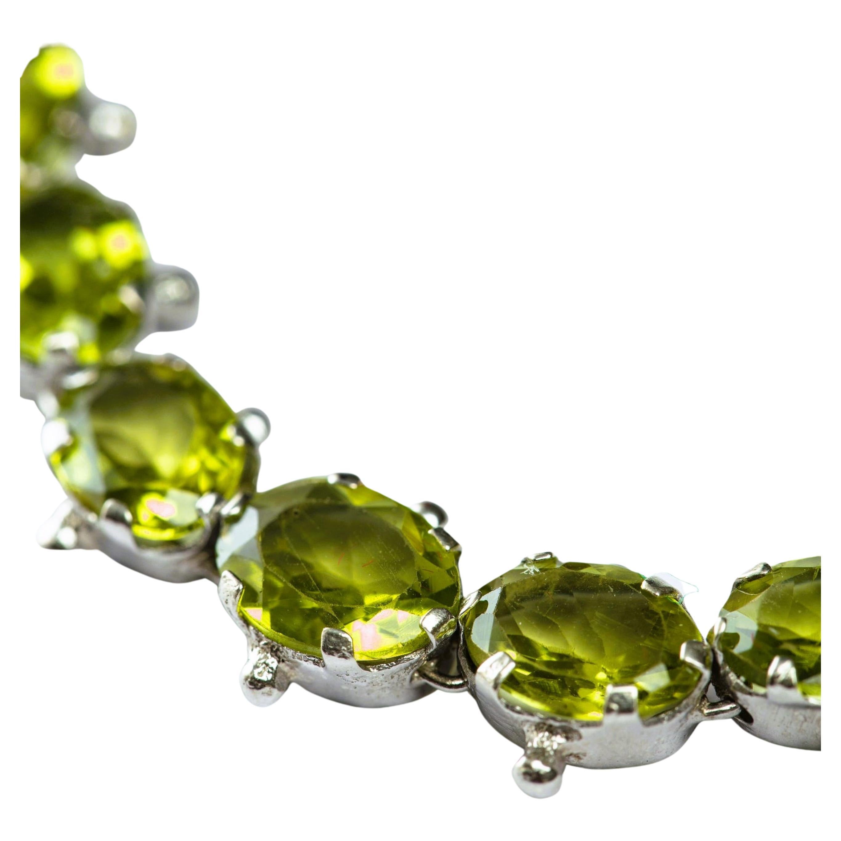 Elevate your style with the beauty and grace of nature. Introducing our pure Green Peridot tennis bracelet, featuring 13 stunning 1ct oval peridot gemstones. This luxurious bracelet is crafted from high-quality platinum silver, ensuring its
