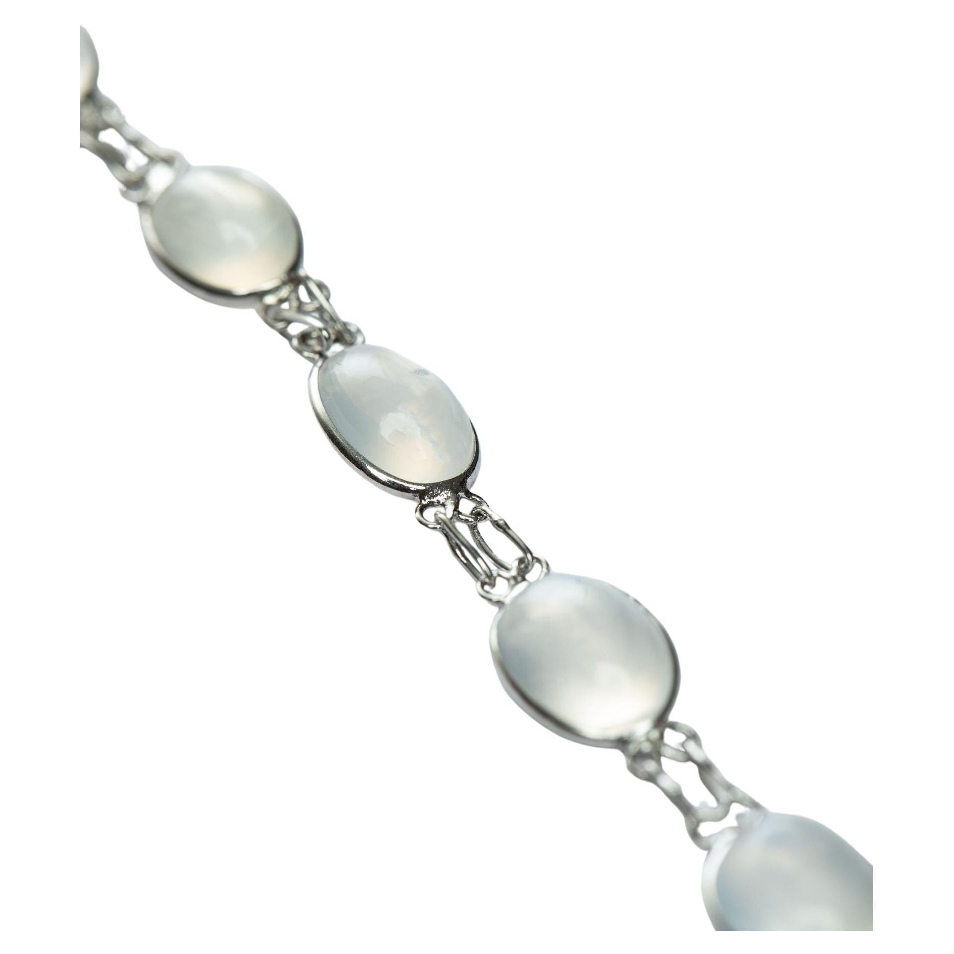  Adorn your wrist with our natural moonstone link bracelet with stunning 12 mixed size stones. Each gemstone is carefully selected for its unique quality and set in a secure setting to create a lasting, mesmerizing piece. Perfect for adding a touch
