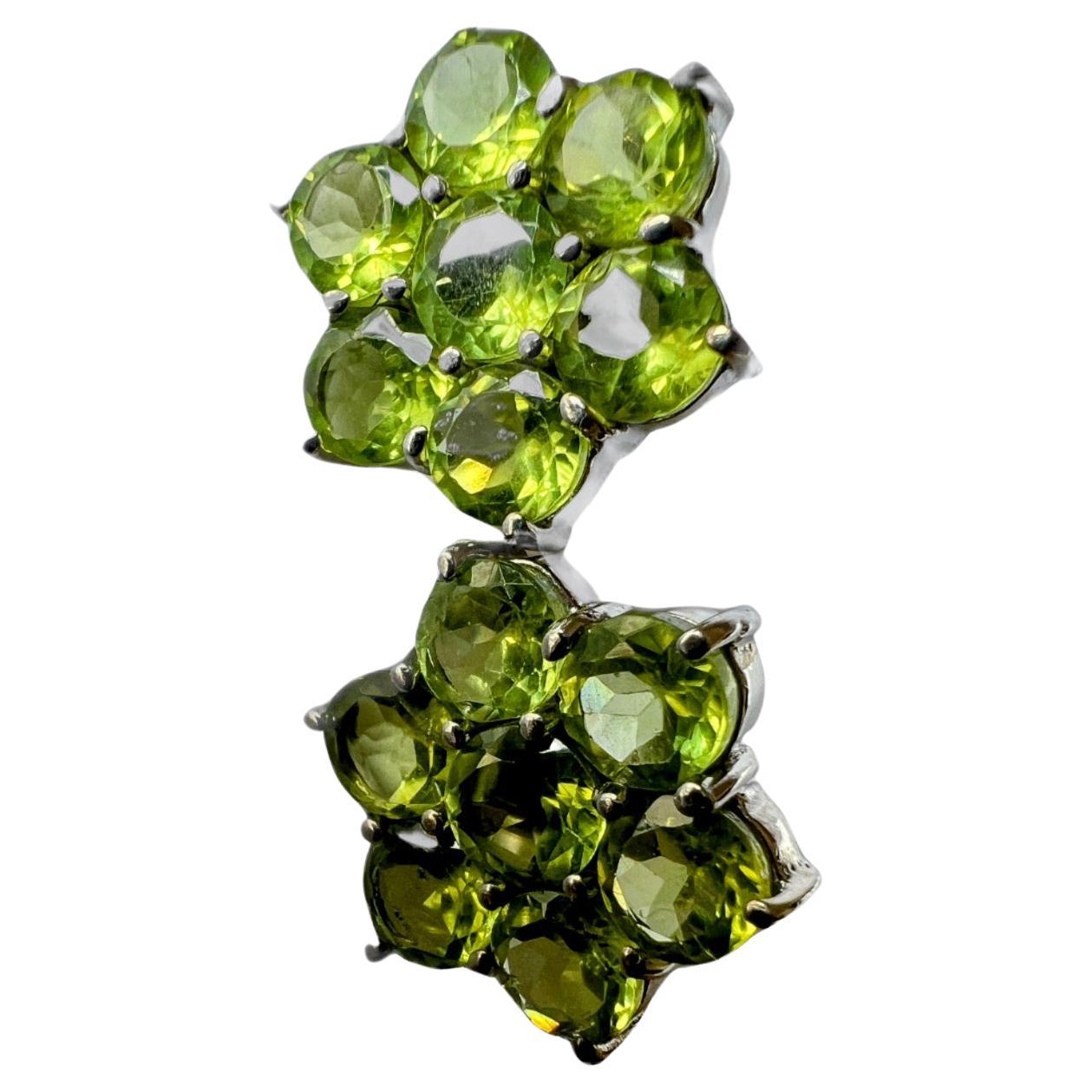 This Mint Green Peridot Stud Earrings on platinum coated sterling silver is a delicate and charming addition to your jewelry collection. 
These earrings feature seven brilliant round-cut peridot gemstones, each measuring 0.75 carats, set in a