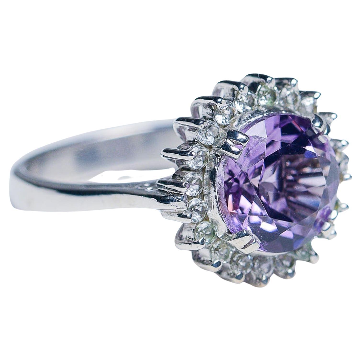 Elevate your style with our exquisite 2.50ct Round Cut Purple Amethyst Statement Ring, a true testament to elegance and sophistication. This captivating ring features a brilliant 2.50ct round cut natural purple amethyst gemstone encircled by 20