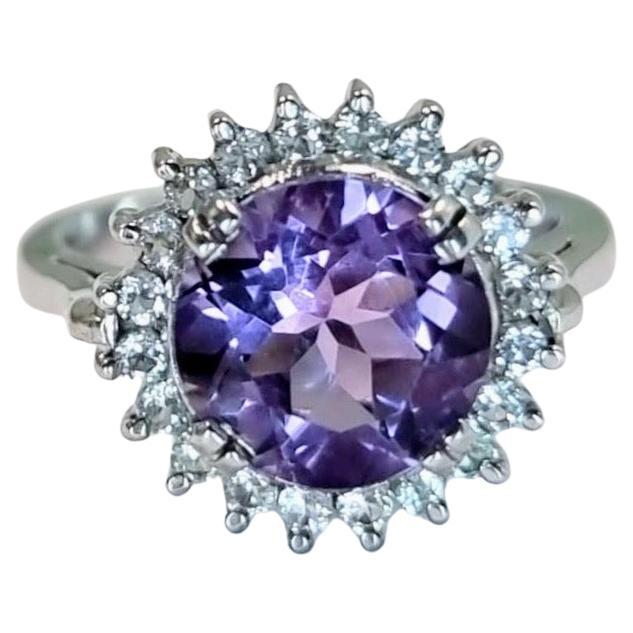 Elevate your style with our exquisite 2.50ct Round Cut Purple Amethyst Statement Ring, a true testament to elegance and sophistication. This captivating ring features a brilliant 2.50ct round cut natural purple amethyst gemstone encircled by 20
