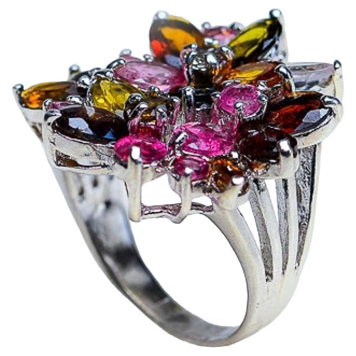Grab this vibrant Rainbow Multi Color Tourmaline Flower Cocktail Ring. Crafted with 22 natural Tourmalines in yellow, green, pink, and blue colors, this stunning floral masterpiece is set in high-quality platinum coated sterling silver. Add a burst