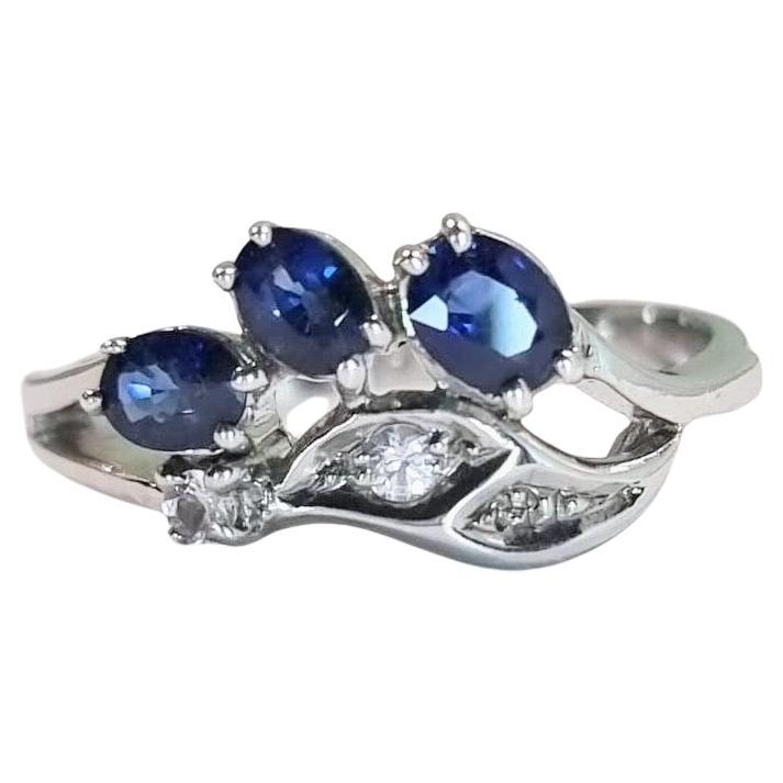 Introducing our .9CTW Oval Natural Blue Sapphire Platinum Silver Vintage-Inspired Leaf Design Ring, a stunning piece that exudes elegance and sophistication. This ring features a mesmerizing 3x .3ct Oval Blue Sapphire design, known for its