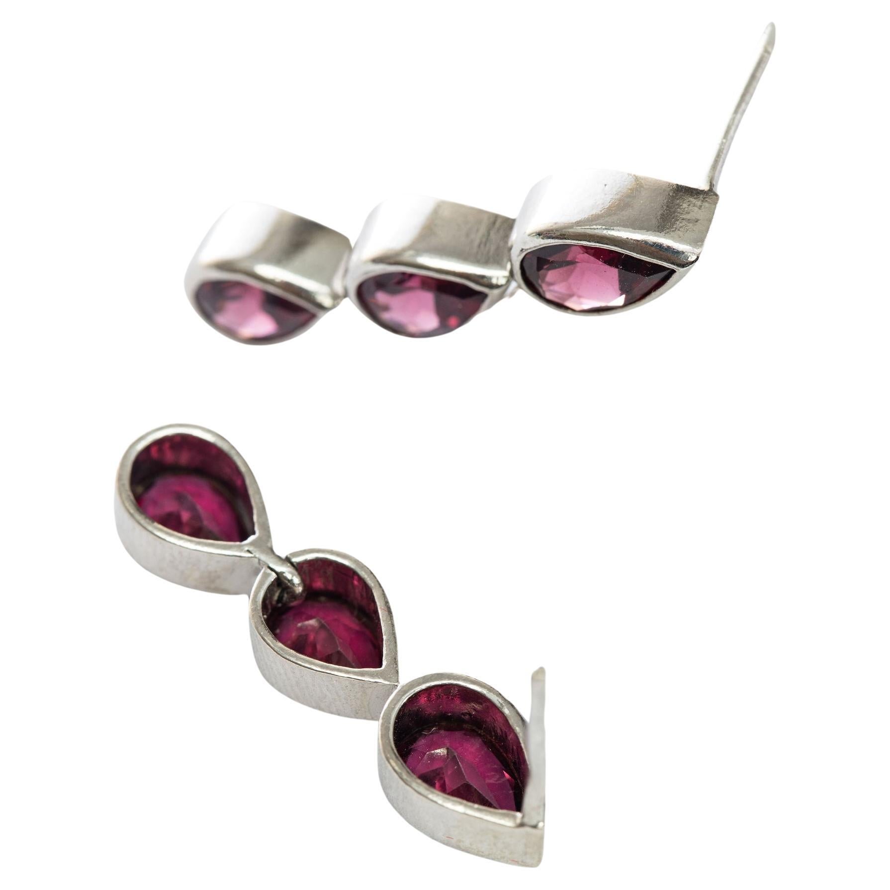 Dress your ears in sophistication with our 3-Stone Pear Cut Garnet Pin Drop Earrings, With a trio of 3 pear cut garnets per earring, these Pin Drop Earrings guarantee maximum sparkle and brilliance, allowing you to effortlessly captivate attention