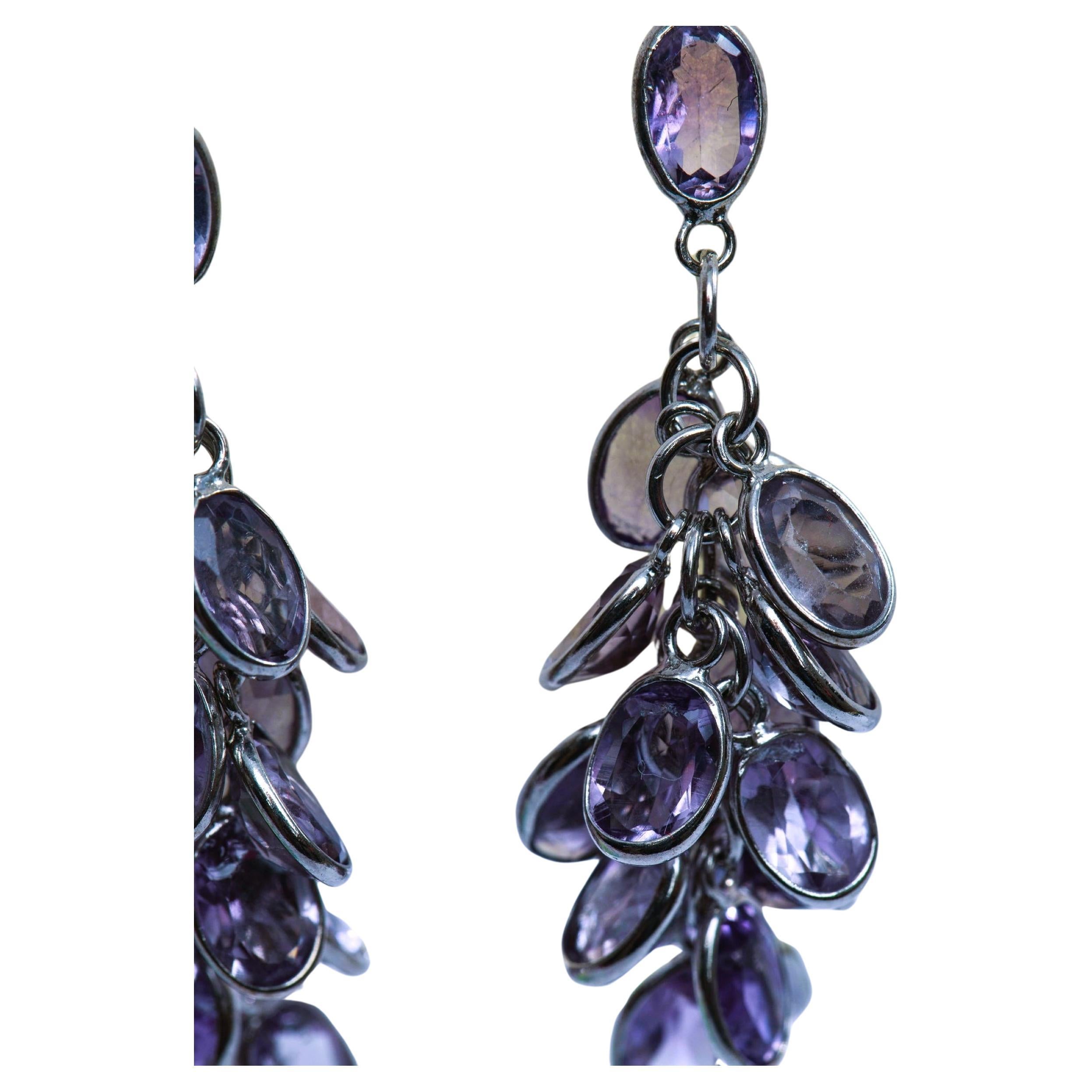 Make a statement with these stunning 10x oval, 1x round and 1x pear shape natural amethyst cluster earrings. Each earring features a cluster of sparkling amethyst gemstones, handpicked for their stunning color and quality. 
Measurements:
Amethyst