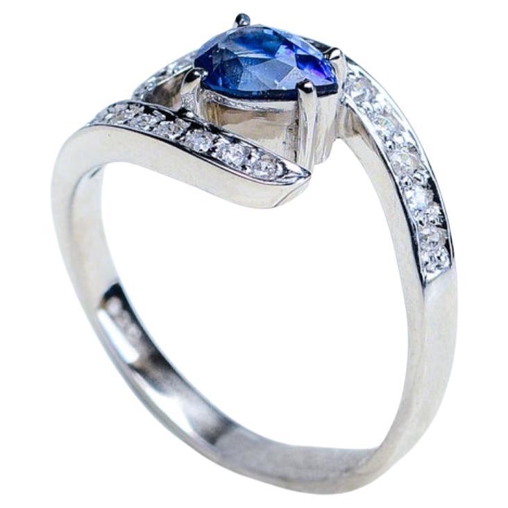 
Introducing our breathtaking 1ct Pear-shaped Blue Sapphire Ring, embraced by a halo of shimmering white natural zircons—a true testament to refined elegance and enduring love. This exquisite ring is a harmonious blend of timeless design and