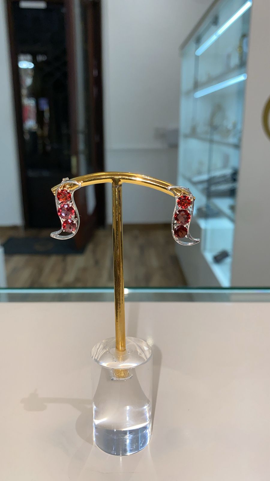 Introducing our exquisite 3 Stone Red Garnet Stud Earrings—a captivating fusion of elegance and nature's charm. Crafted in the shape of a pod, these earrings encapsulate the essence of growth and renewal, with three vibrant garnets symbolizing the