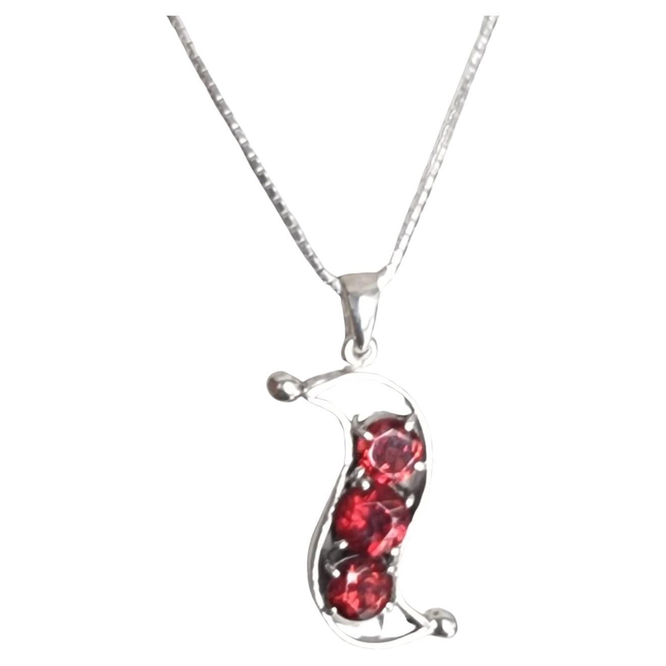 Introducing our stunning 3 Stone Red Garnet Pod Pendant Necklace—a mesmerizing blend of elegance and nature-inspired design. Crafted with meticulous attention to detail, this exquisite necklace features three round garnet gemstones, each weighing
