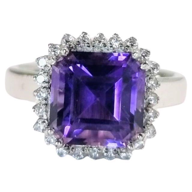 Introducing our exquisite 4ct Cushion Cut Amethyst Cocktail Ring, a statement piece that exudes elegance . This stunning ring features a cushion-cut amethyst, weighing a generous 4 carats, set in sterling silver. 

Center Stone:
Type: Natural