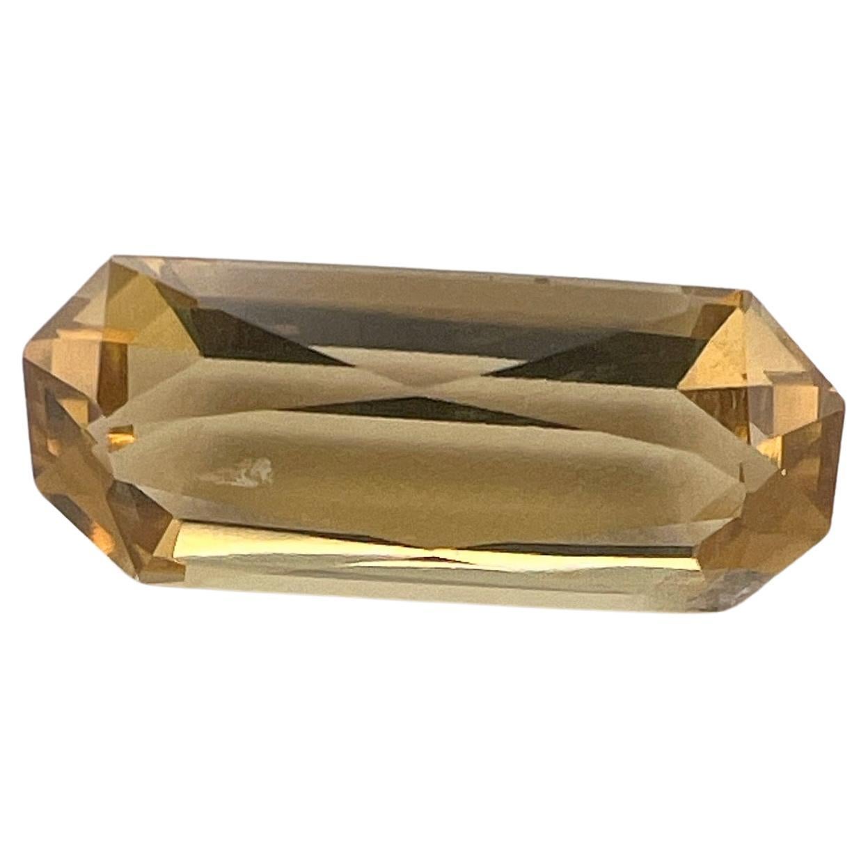 Dazzle and shine with our 6.39ct Baguette Cut Natural UNHEATED Citrine, a gemstone that radiates sophistication and elegance. Measuring 17.4mm in length and 7.3mm in width, this citrine is a perfect embodiment of precision and style. Its elongated