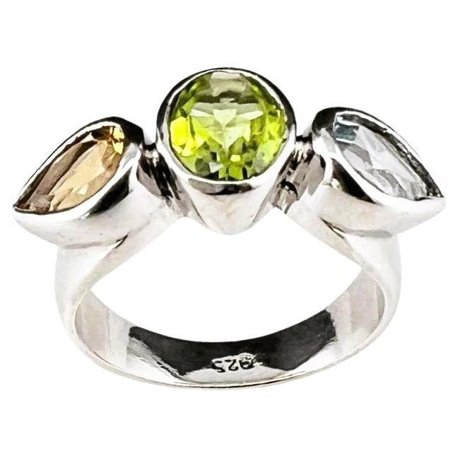 Elegant Natural and untreated Three Stone Dome Ring: Peridot, citrine and Topaz Fusion.  

Elegance and beauty intertwine in this exquisite three stone cocktail ring. Weighing a substantial 5.63g, this ring features three captivating gemstones - a