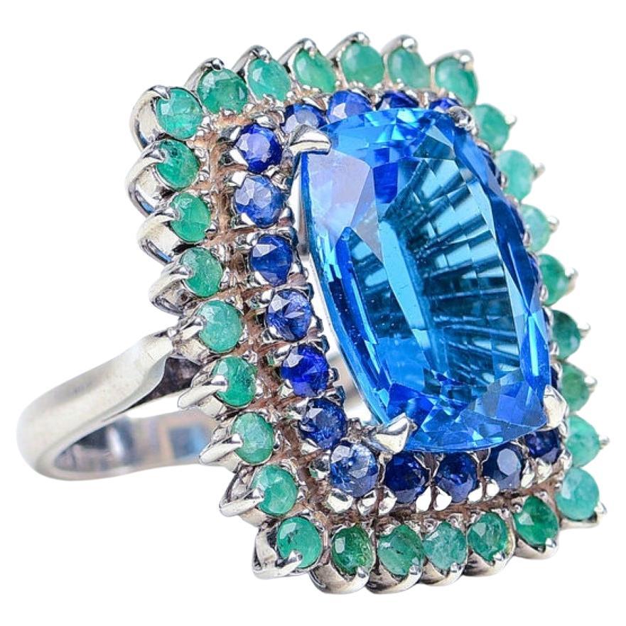 Custom Platinum Blue Topaz Cocktail Ring with Emerald and Sapphire Halo For Sale 2
