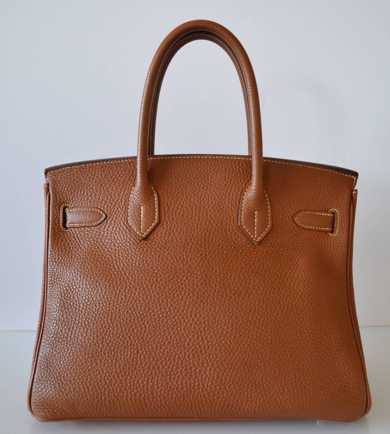 Hermes Birkin 30 Togo Gold
 
Togo leather with gold plated hardware
 
Very Good condition 
Stamp G
Hermes Paris - Made In France
 
Togo leather is in very good condition - Interior is odorless - Corners are good - Hardware is in very good