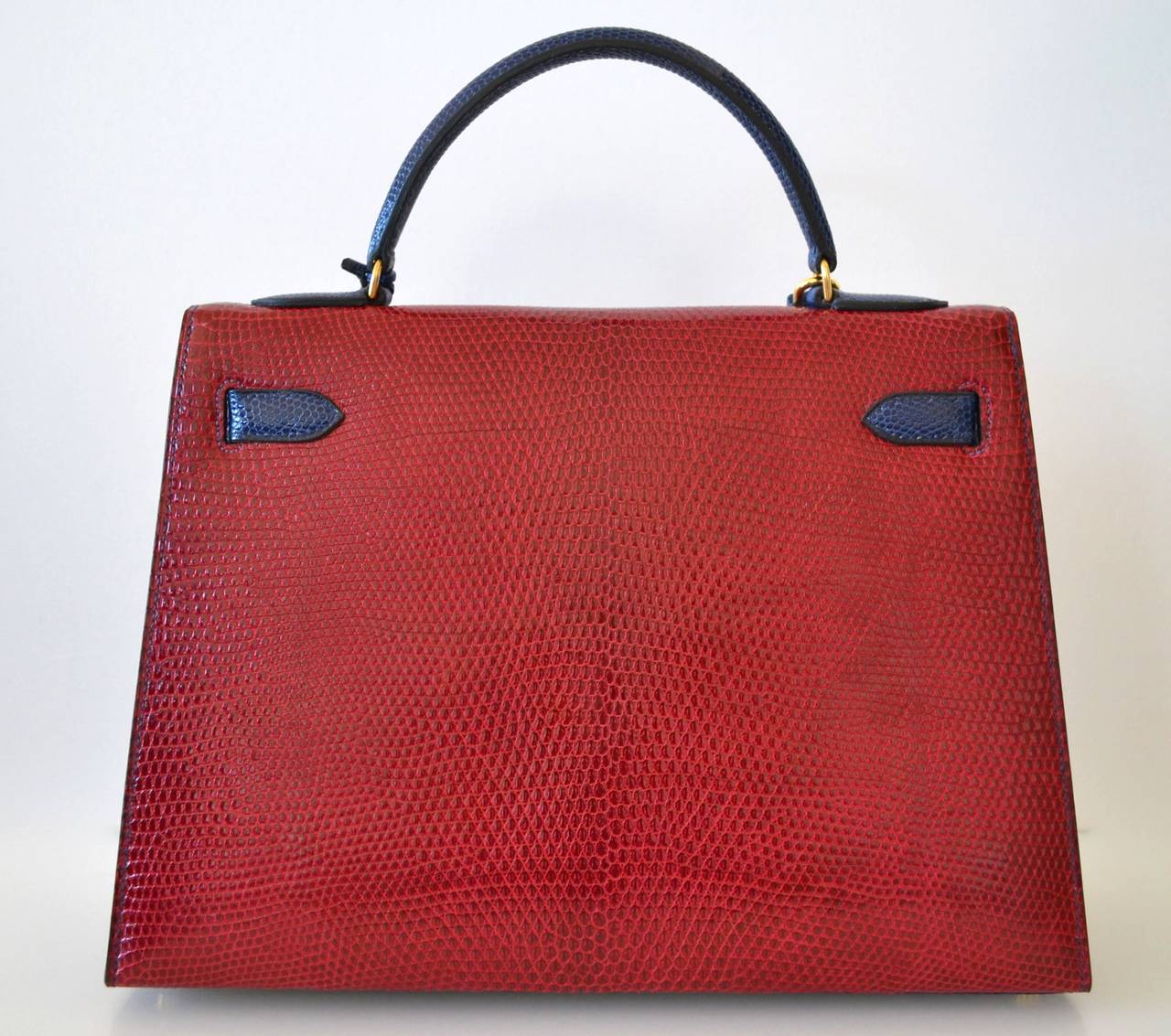 Hermes Kelly 32 Lizard Tricolore
 
Lizard skin
Vert Foret – Bleu Saphir – Rouge Hermes
The bag is lined with Rouge H chevre leather.
 
This bag is in very good condition 7/10
This item is in very good condition with gentle few signs of use.
