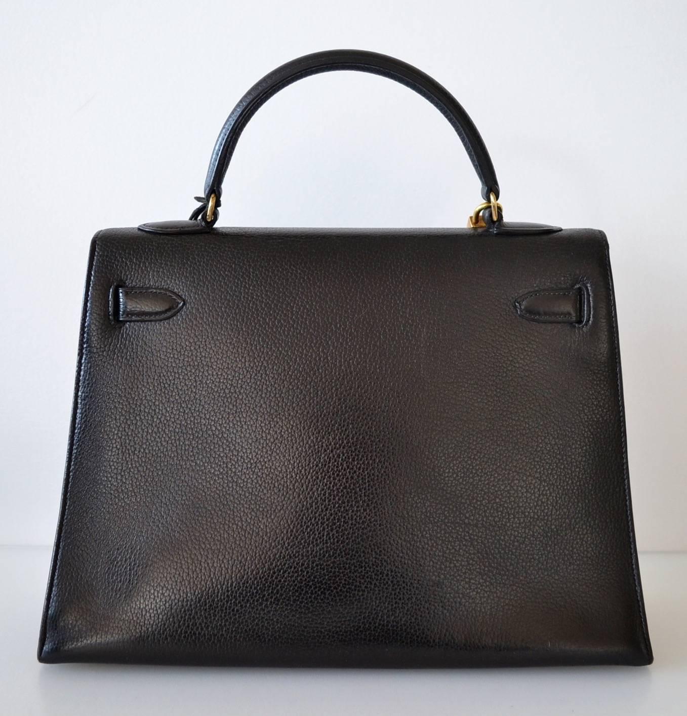 Hermès Kelly 32 Black Veau Graine 
 
Vintage model and rare in grained leather
Veau Graine leather  - Black color with gold hardware
Sellier model
 
This beautiful Kelly handbag is in very good condition.
Hardware have normal